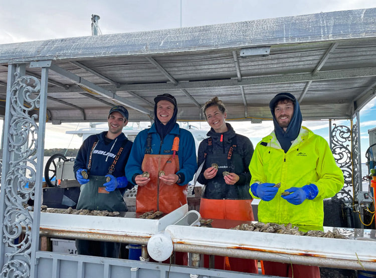 Maine Oysters Farmers holding oysters
